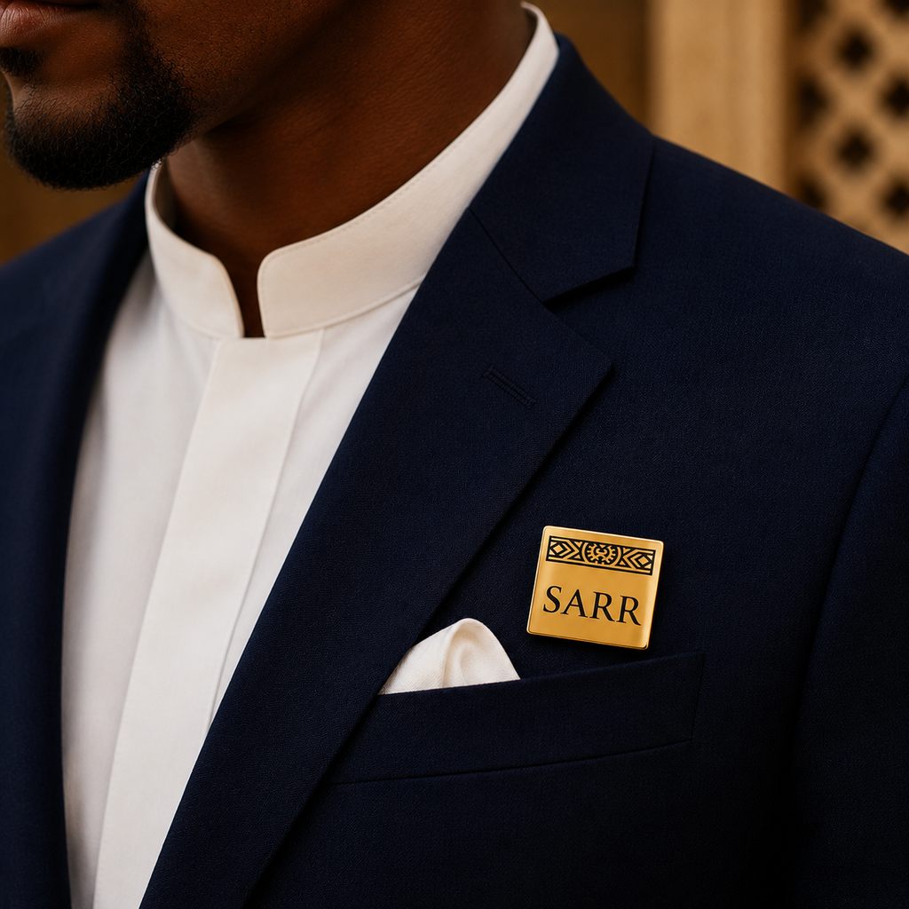 Pin's personnalisé LIGNÉE doré porté sur costume bleu